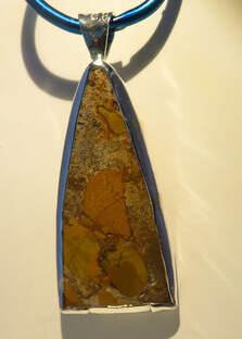 Sterling silver pendant with handmade bezel-set yellow agate triangular cabochon