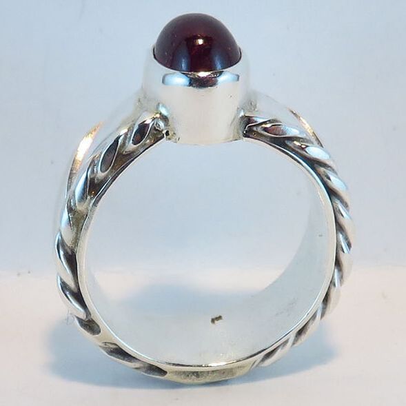 Sterling silver ring with spiral edges on shank and ruby cabochon