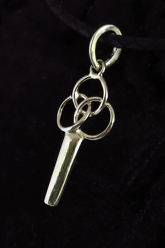 Sterling silver pendant handmade symbol of 'strength in unity' three circles on a shaft against a black backgroundPicture